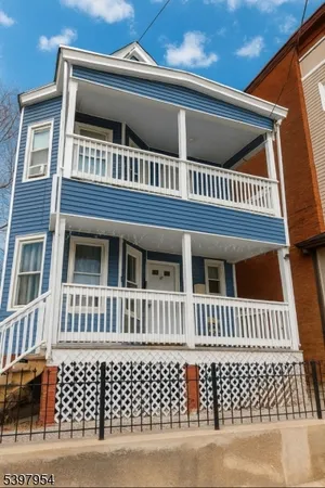 a front view of a house with a wooden fence