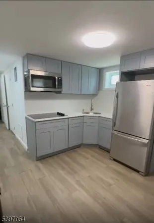 a kitchen with stainless steel appliances a refrigerator sink and microwave