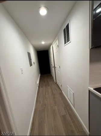 a view of hallway with wooden floor