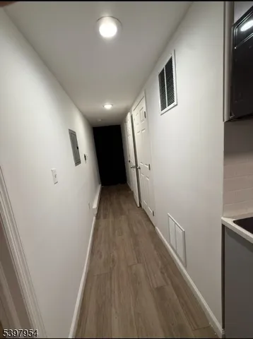 a view of hallway with wooden floor