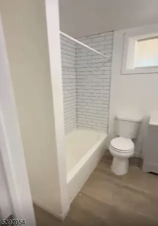 a bathroom with a toilet and a bathtub