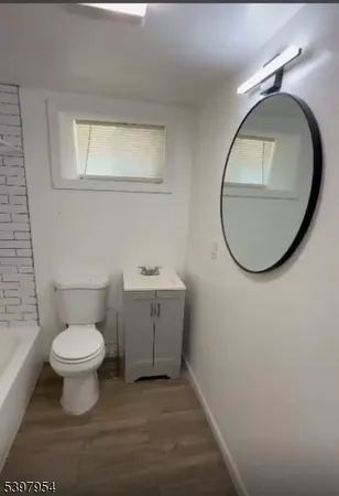 a bathroom with a toilet sink and a mirror