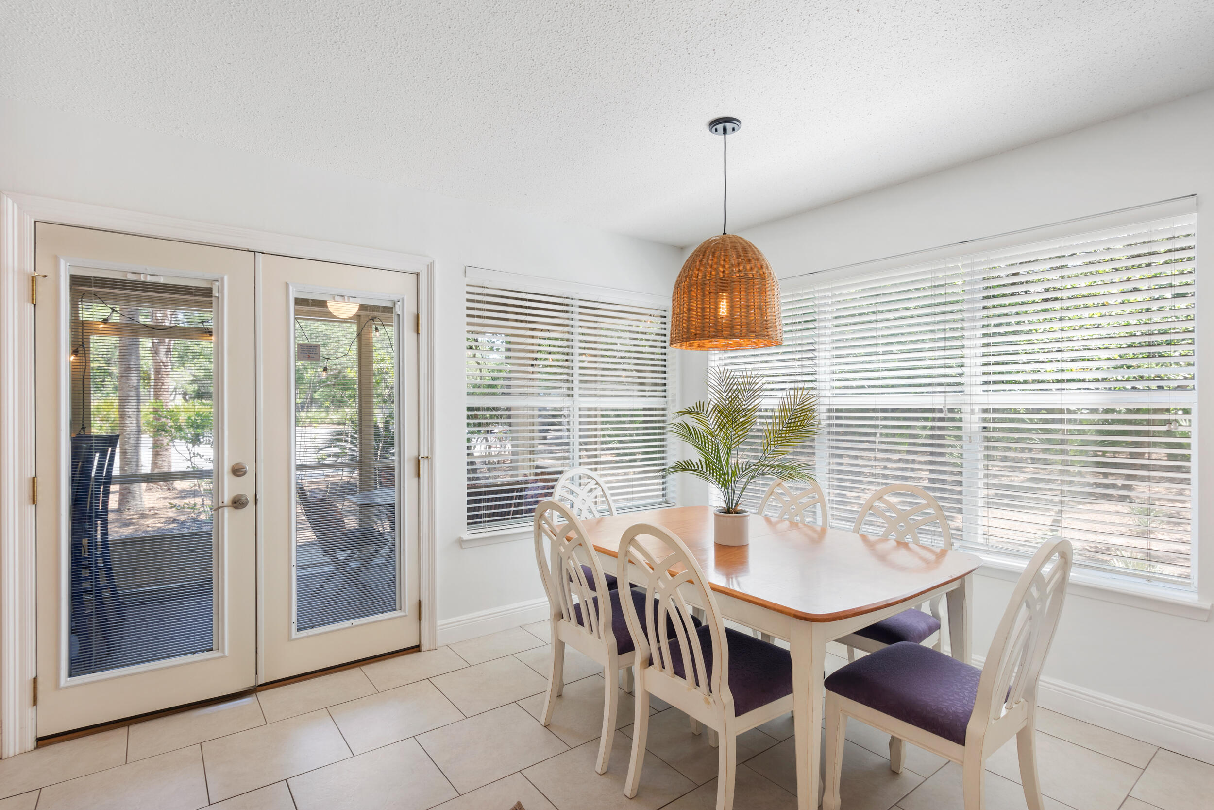 9815 Highway 98, Unit 144 Miramar Beach, FL 32550 - Photo 11 of 70 a dining room with furniture a chandelier and wooden floor