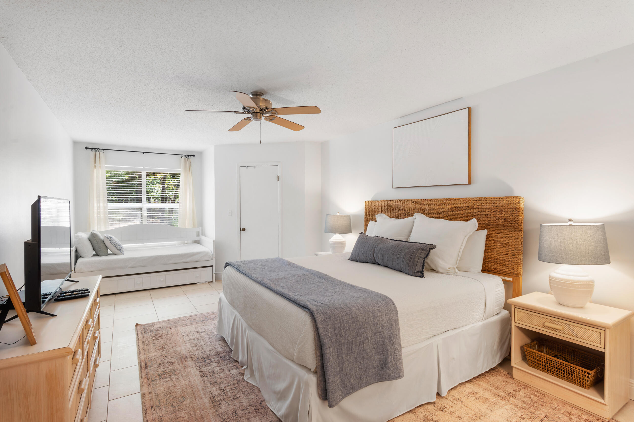 9815 Highway 98, Unit 144 Miramar Beach, FL 32550 - Photo 18 of 70 a bedroom with a bed a couch and a flat tv screen on the dresser