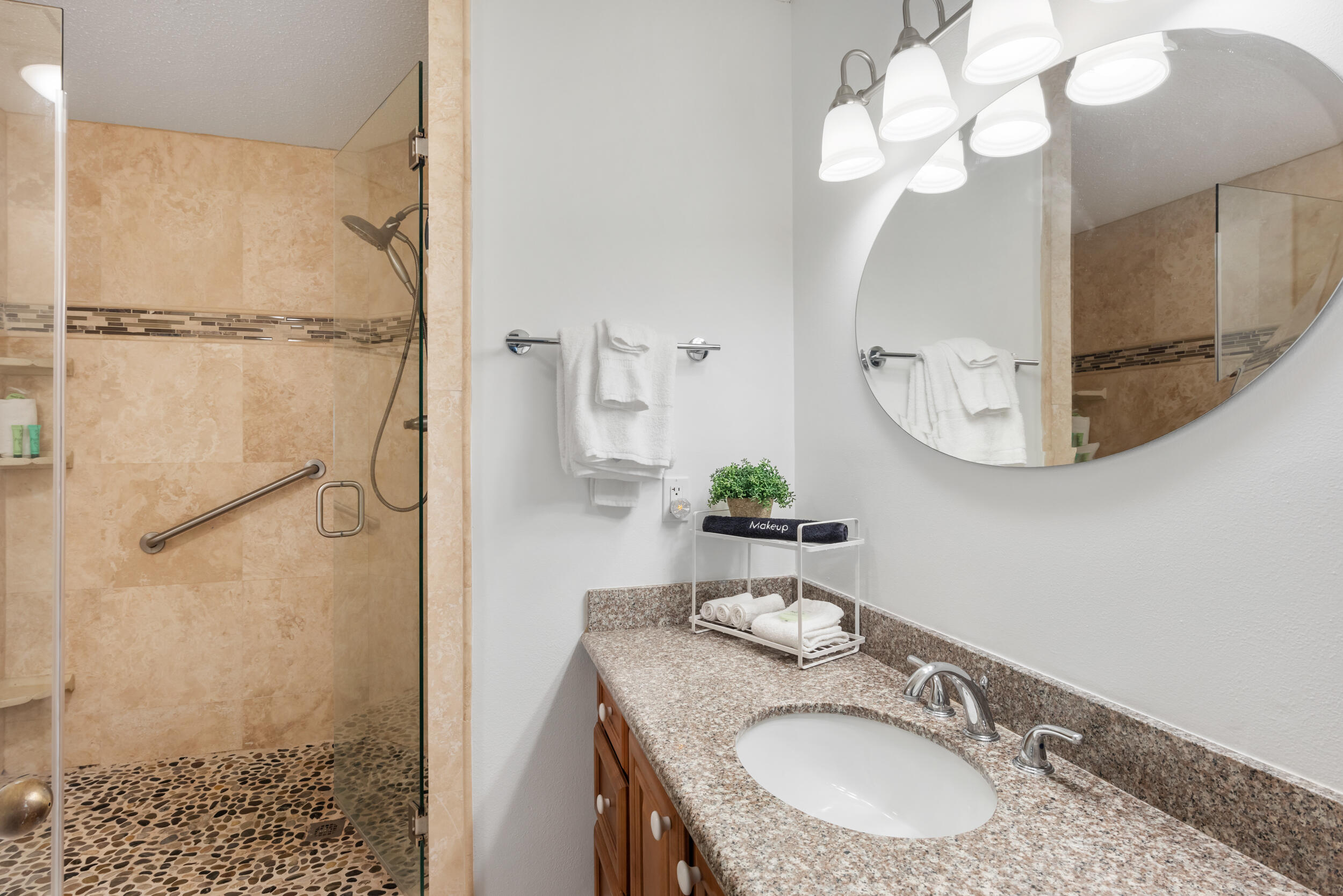 9815 Highway 98, Unit 144 Miramar Beach, FL 32550 - Photo 23 of 70 a bathroom with a granite countertop sink a mirror and shower