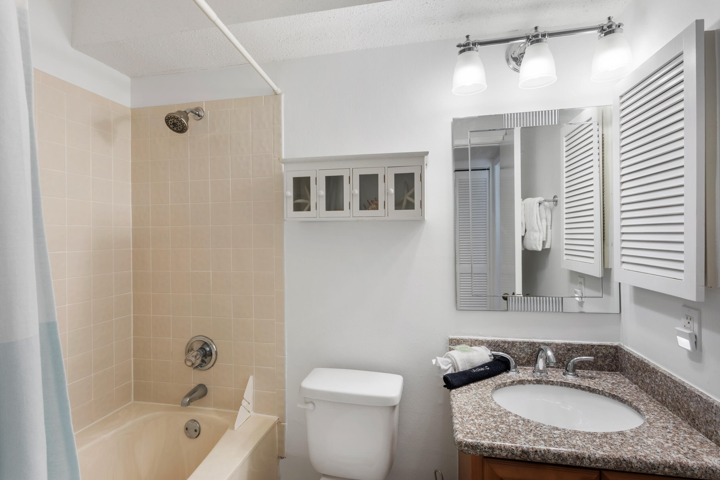 9815 Highway 98, Unit 144 Miramar Beach, FL 32550 - Photo 28 of 70 a bathroom with a granite countertop sink toilet and shower