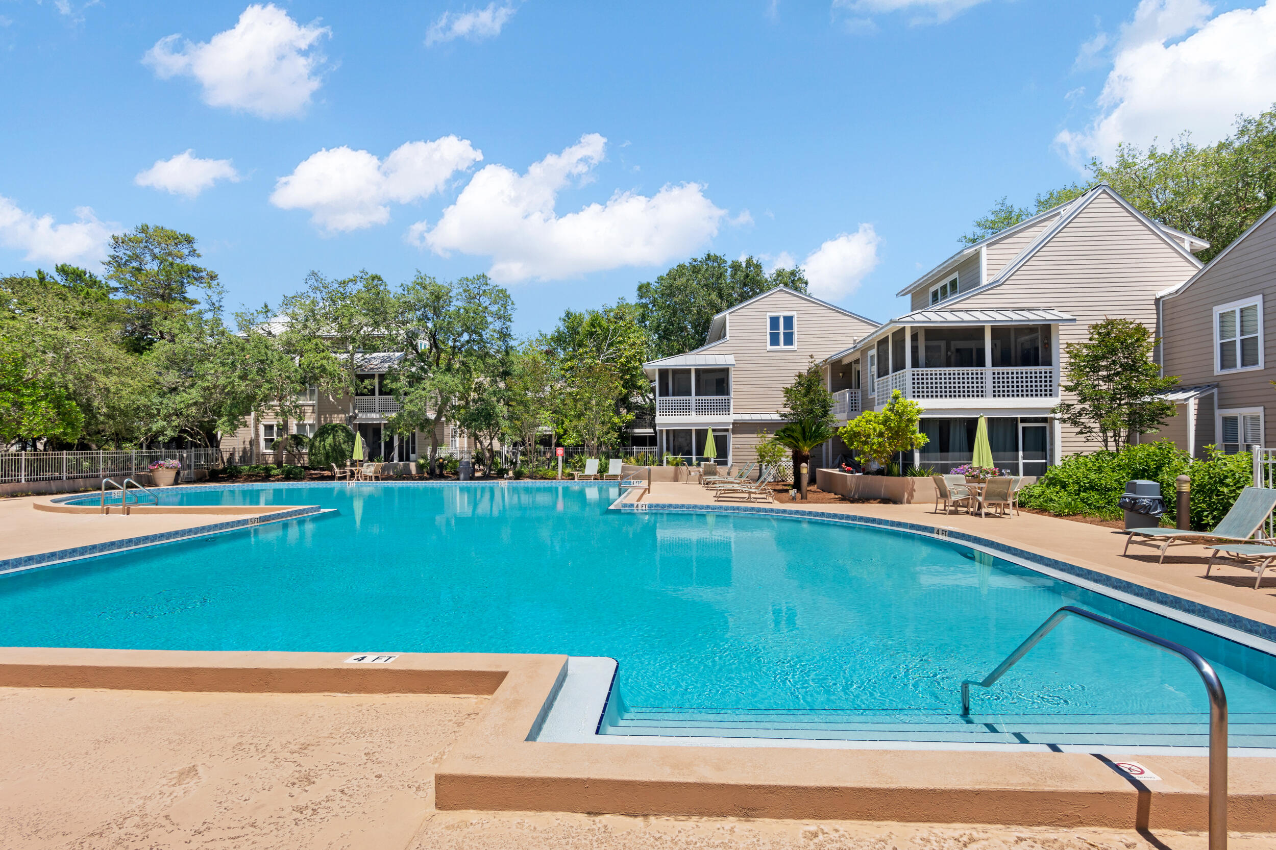 9815 Highway 98, Unit 144 Miramar Beach, FL 32550 - Photo 36 of 70 a view of a swimming pool with lawn chairs and plants