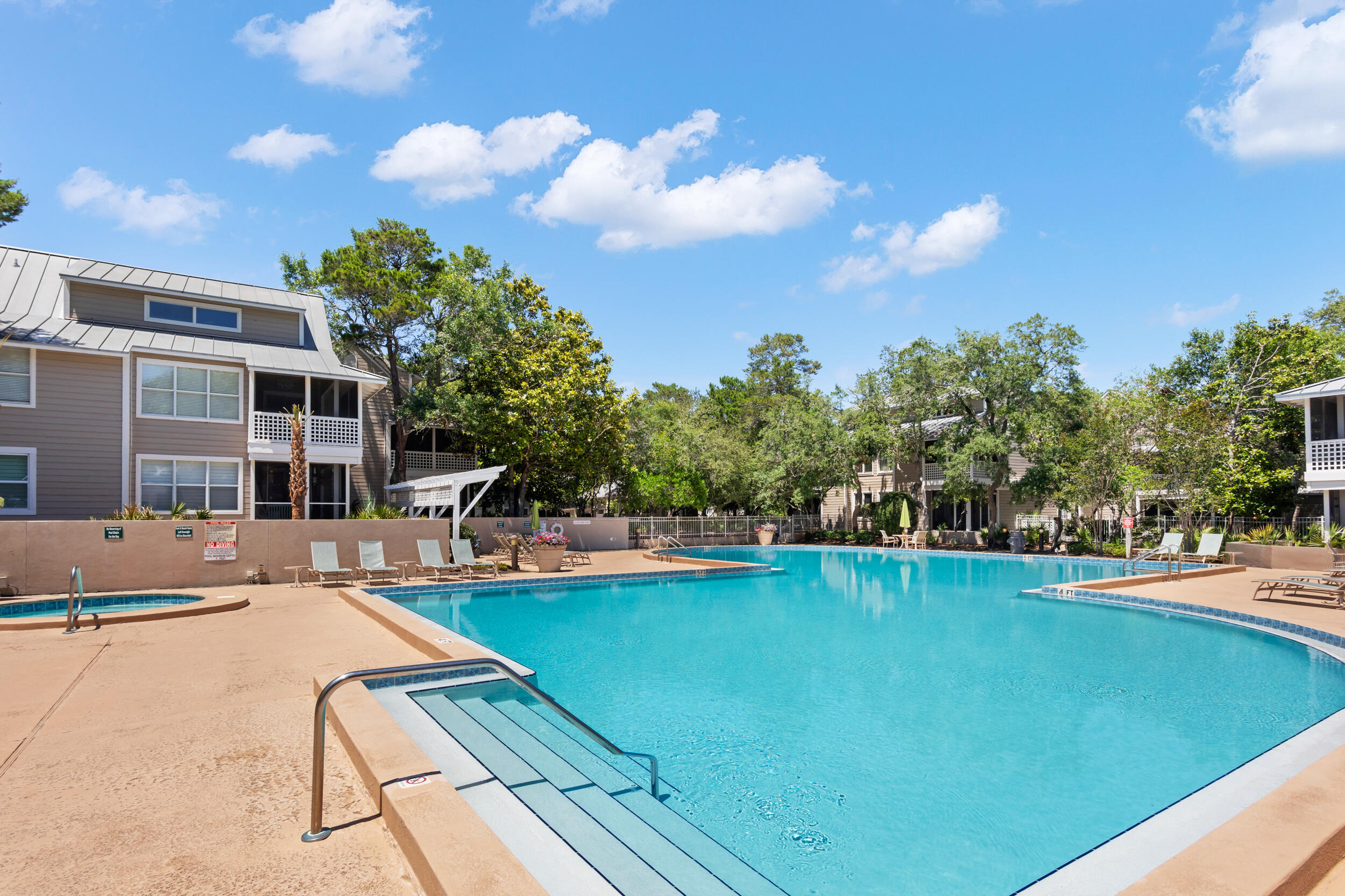 9815 Highway 98, Unit 144 Miramar Beach, FL 32550 - Photo 37 of 70 a view of a swimming pool with a lounge chairs