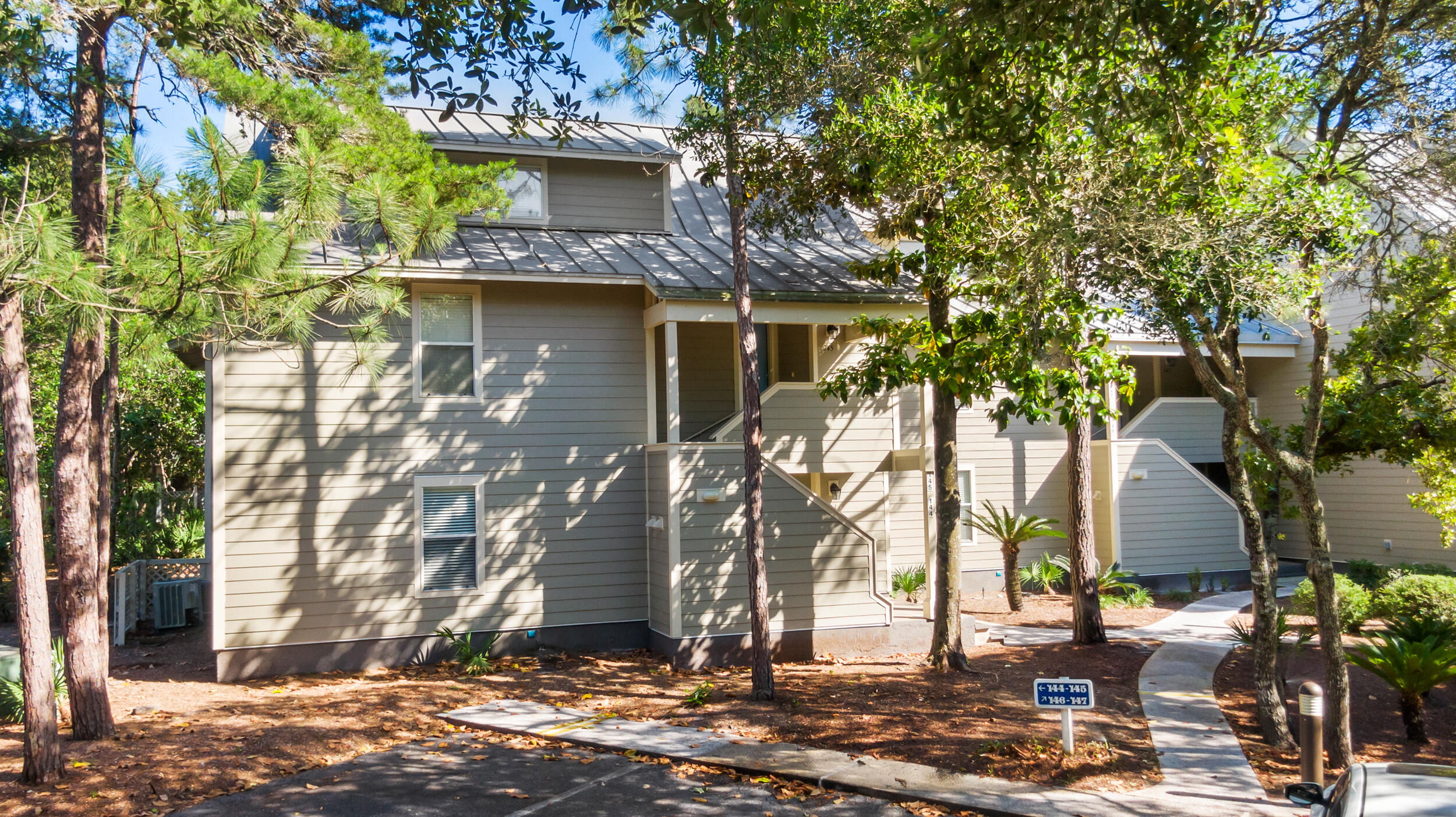 9815 Highway 98, Unit 144 Miramar Beach, FL 32550 - Photo 4 of 70 a view of house with a tree in front