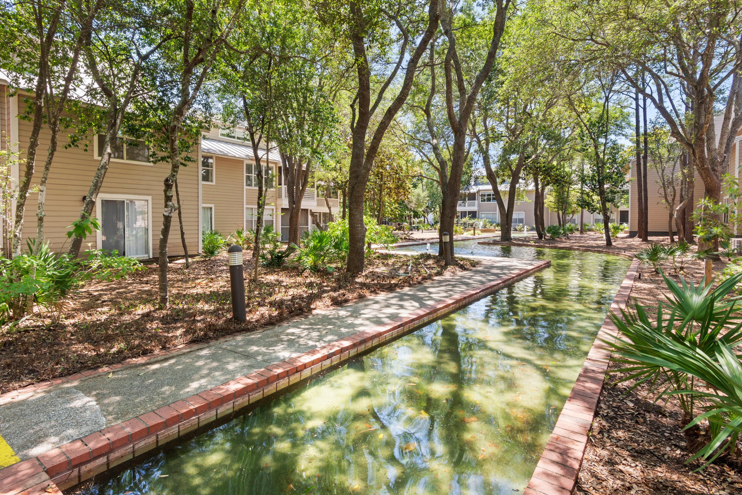 9815 Highway 98, Unit 144 Miramar Beach, FL 32550 - Photo 41 of 70 a backyard of a house with lots of green space