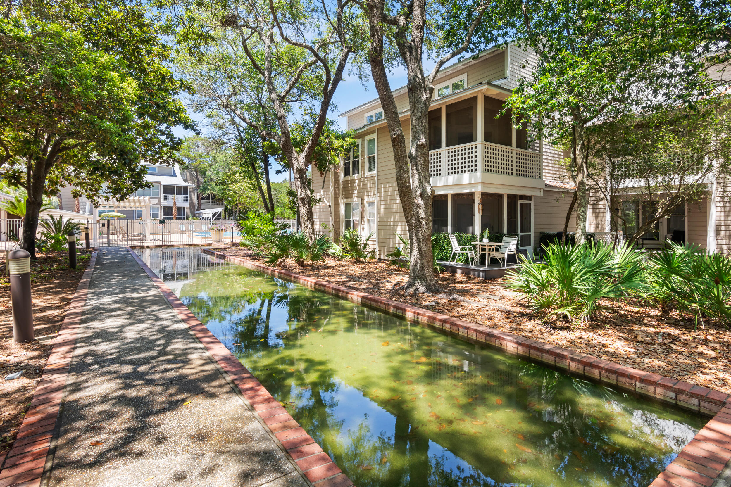 9815 Highway 98, Unit 144 Miramar Beach, FL 32550 - Photo 42 of 70 a front view of a house with a yard table and chairs