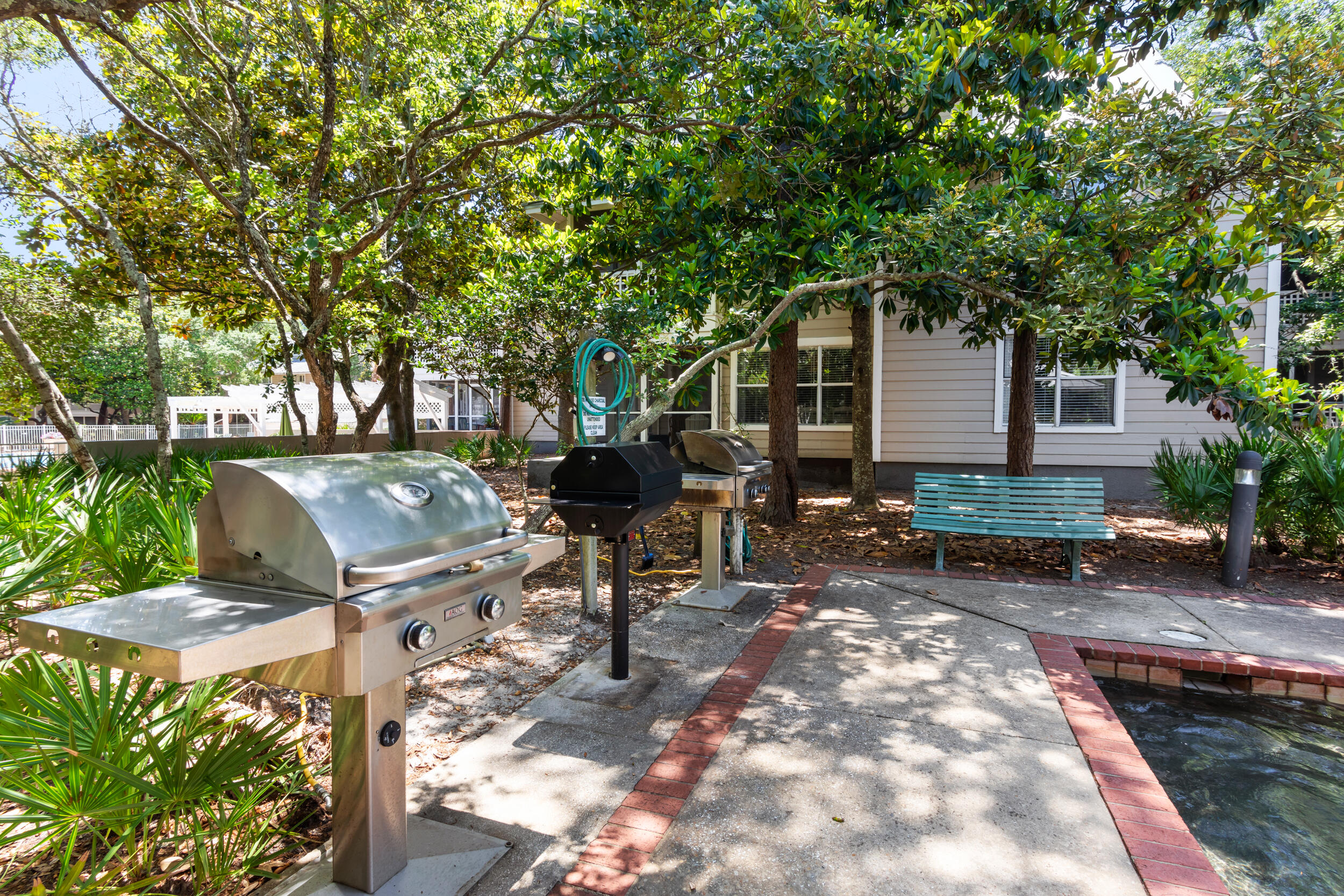 9815 Highway 98, Unit 144 Miramar Beach, FL 32550 - Photo 43 of 70 a backyard of a house with table and chairs