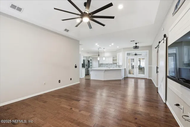 a view of empty room with fireplace and wooden floor