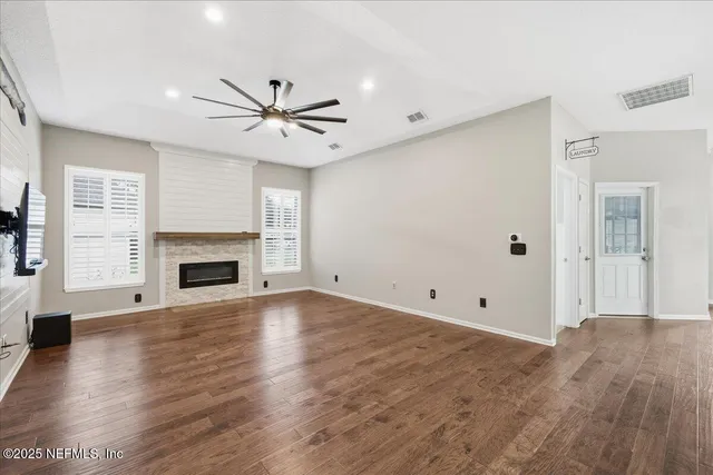 a bathroom with a double vanity sink a toilet a mirror and shower