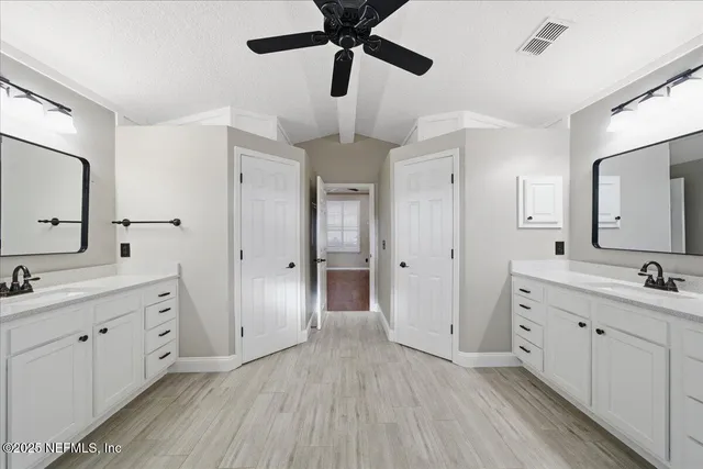 a view of a patio with a table and chairs and potted plants