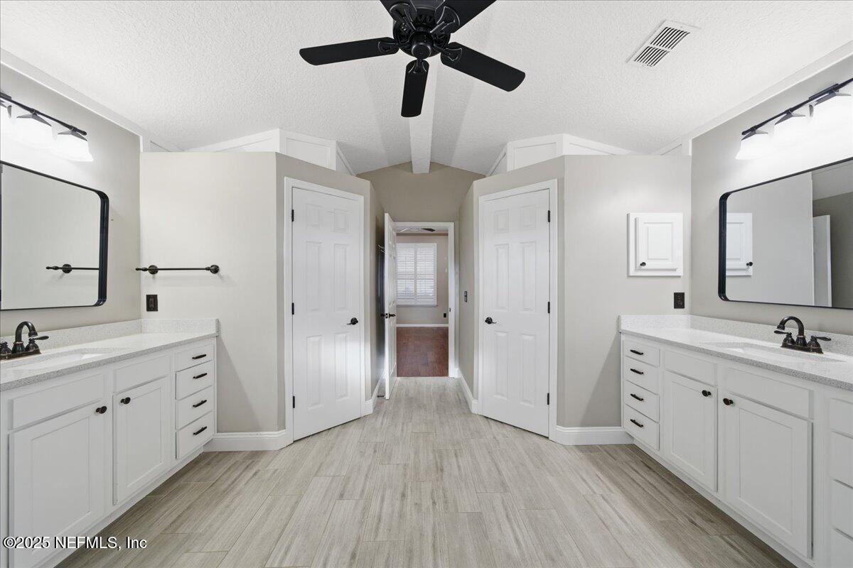 4032 Lonicera Loop St. Johns, FL 32259 - Photo 26 of 113 a spacious bathroom with a double vanity sink a mirror and a shower
