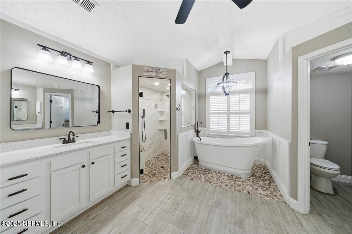4032 Lonicera Loop St. Johns, FL 32259 - Photo 29 of 113 a bathroom with a double vanity sink toilet mirror and shower