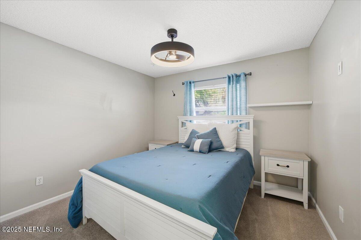 4032 Lonicera Loop St. Johns, FL 32259 - Photo 34 of 113 a bedroom with a bed and a chandelier