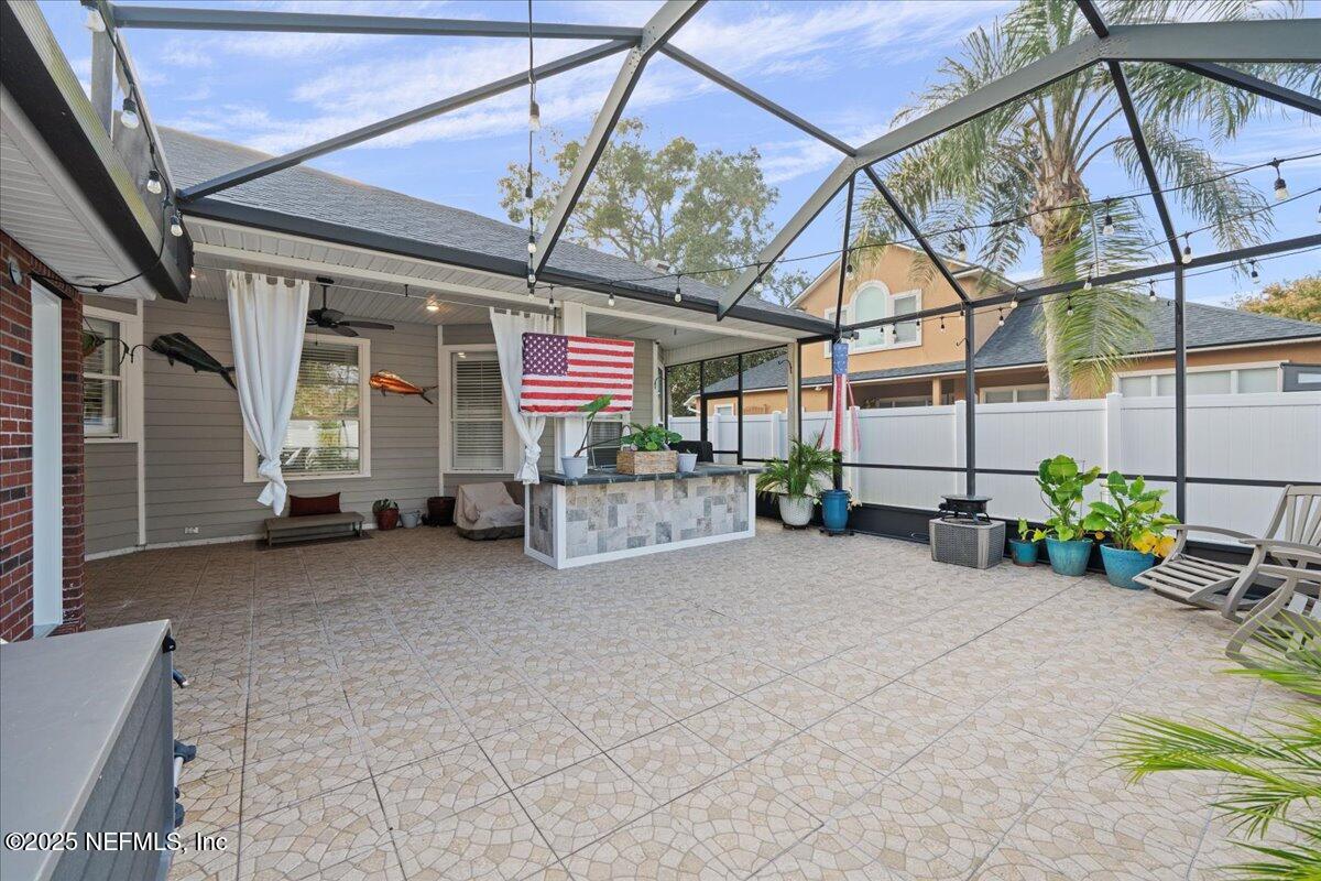 4032 Lonicera Loop St. Johns, FL 32259 - Photo 45 of 113 a view of a patio with a table and chairs and potted plants