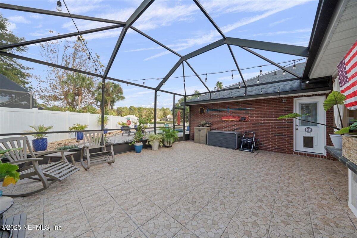 4032 Lonicera Loop St. Johns, FL 32259 - Photo 47 of 113 a view of patio with a table and chairs under an umbrella