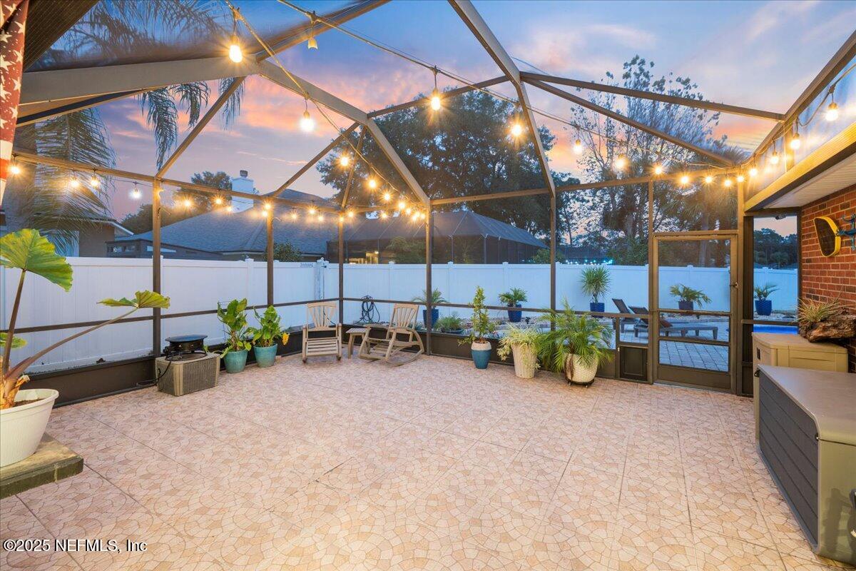 4032 Lonicera Loop St. Johns, FL 32259 - Photo 49 of 113 a view of a garage with a table and chairs under an umbrella