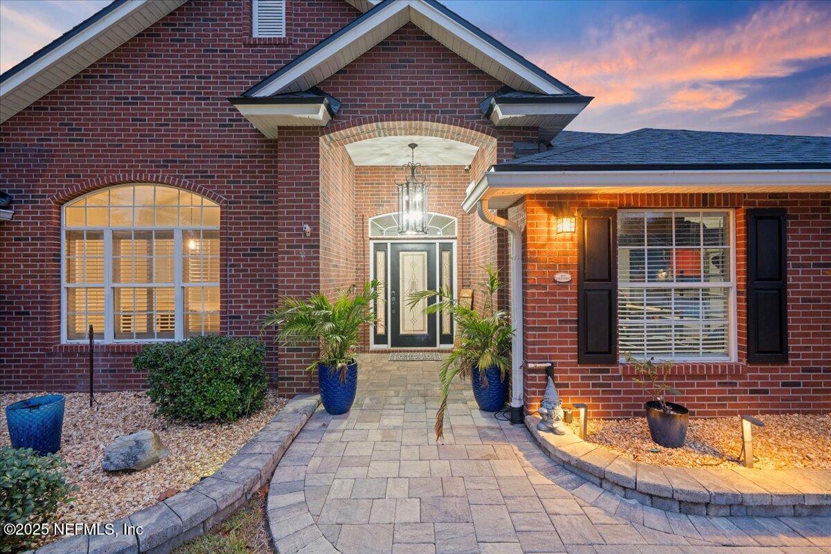 4032 Lonicera Loop St. Johns, FL 32259 - Photo 73 of 113 a view of a brick house with many windows and potted plants