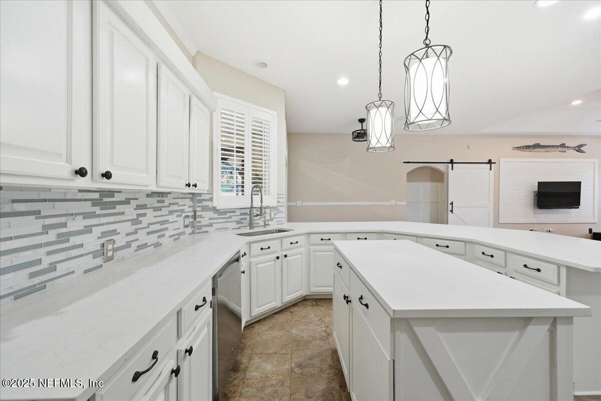4032 Lonicera Loop St. Johns, FL 32259 - Photo 9 of 113 a kitchen with a sink stove and white cabinets with wooden floor