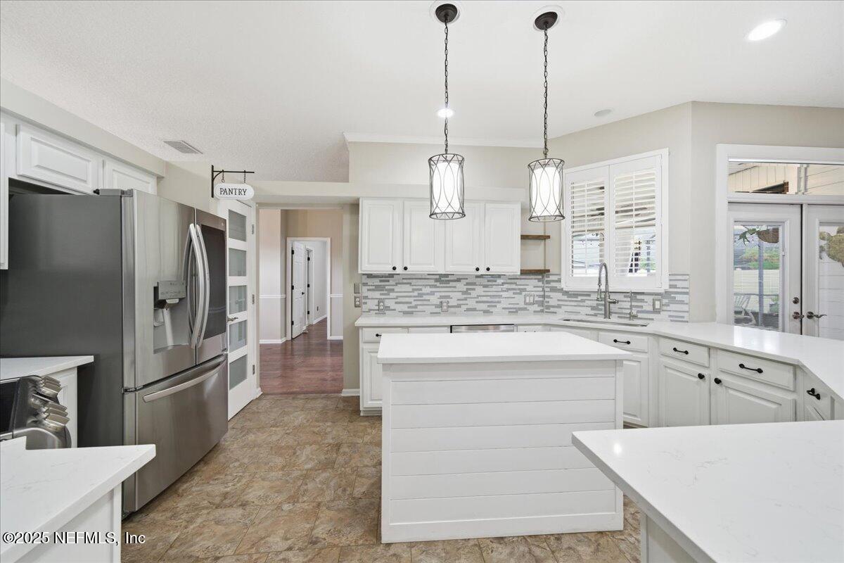 4032 Lonicera Loop St. Johns, FL 32259 - Photo 10 of 113 a large kitchen with kitchen island a sink stainless steel appliances and cabinets