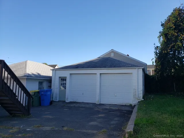 a view of house with yard and garage