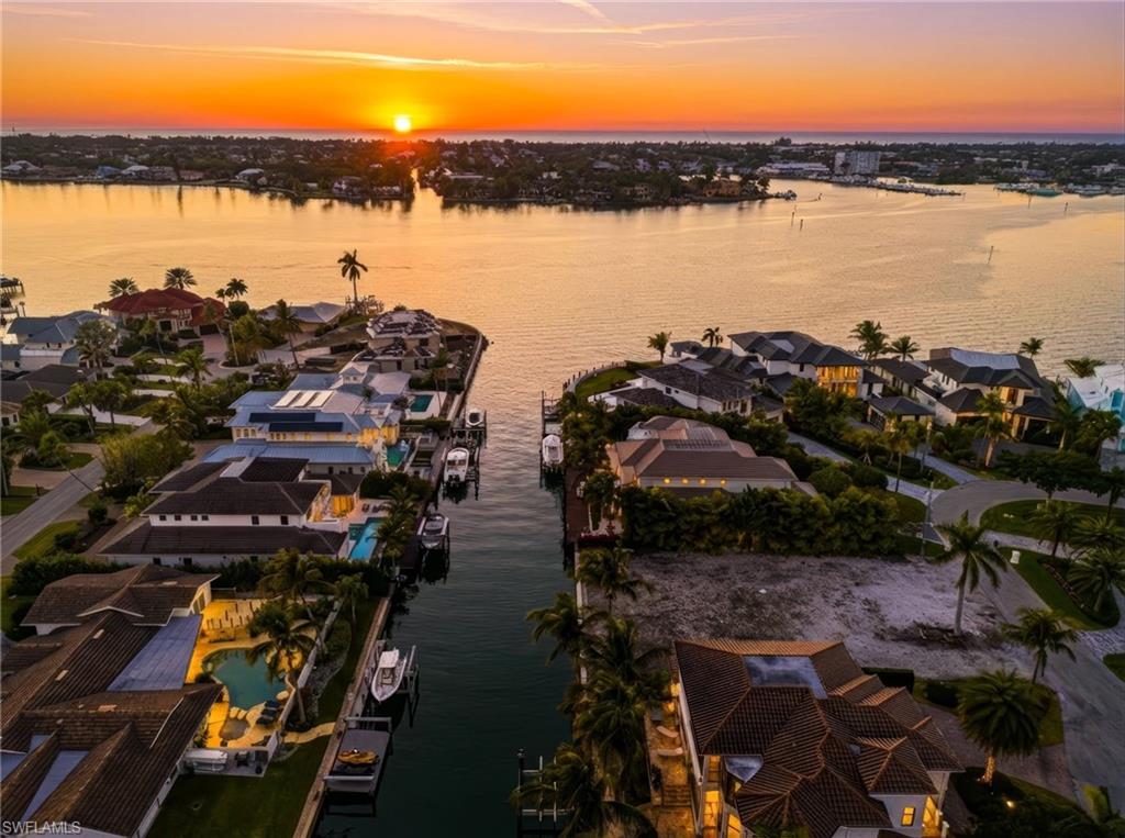 1670 Dolphin Court Naples, FL 34102 - Photo 2 of 30 Just two lots from Naples Bay, providing easy access to the Gulf & Keewaydin Island.