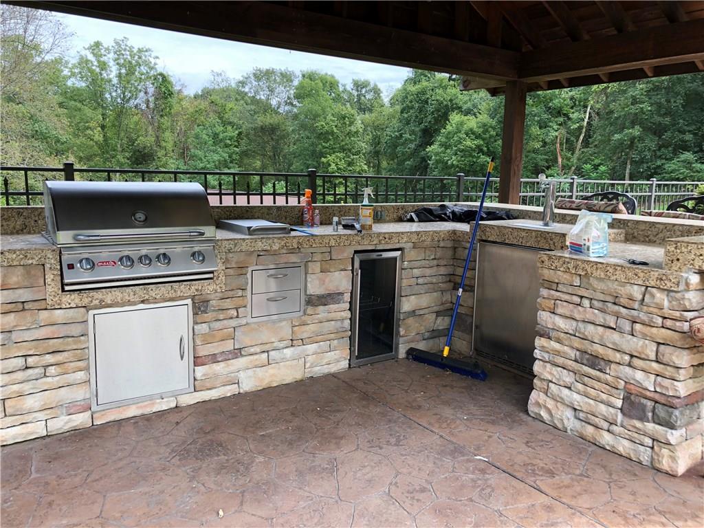 31 Dovercrest Road Eighty Four, PA 15330 - Photo 21 of 23 Outdoor kitchen under pavilion with retractable sunshade featuring solid granite top and beer meister.