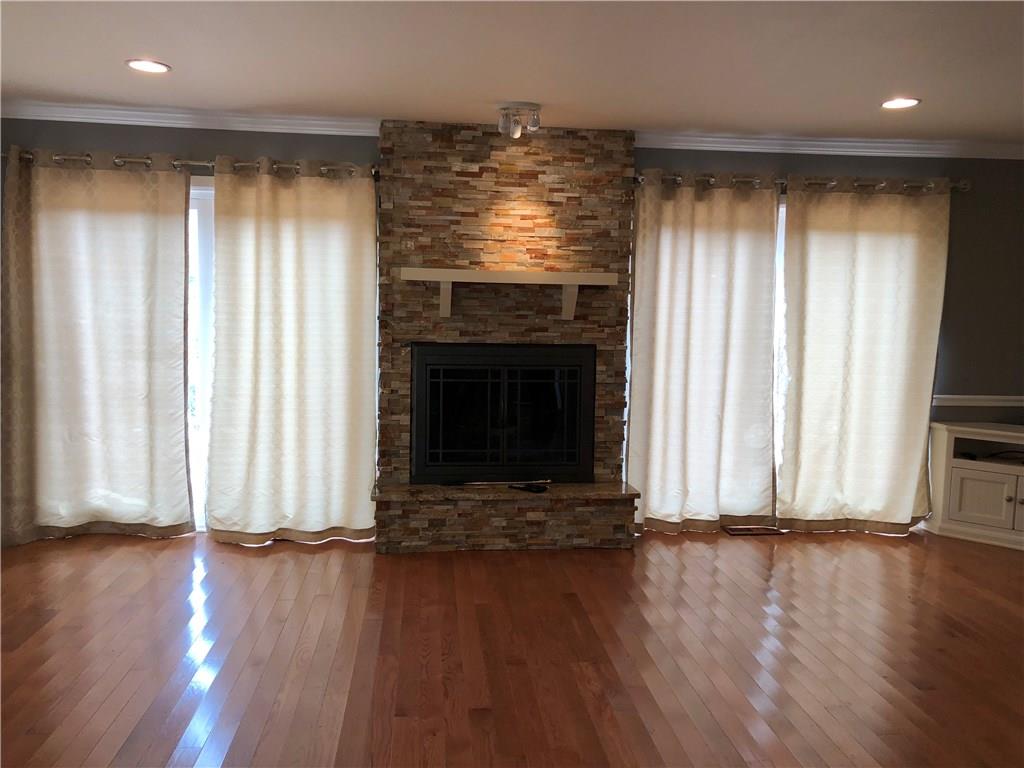 31 Dovercrest Road Eighty Four, PA 15330 - Photo 6 of 23 Living room with wood burning fireplace and deck access which views the rear of the property.