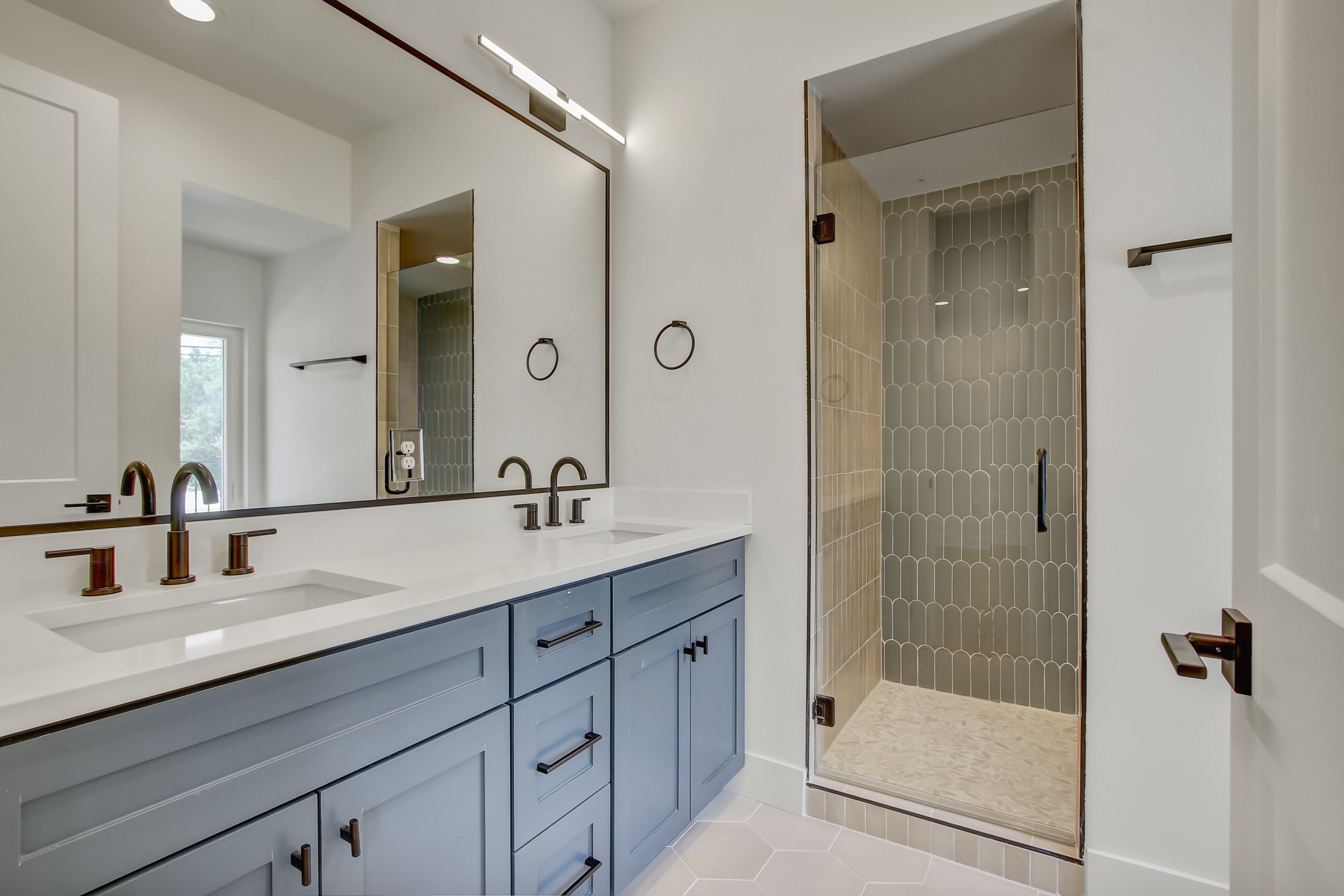 4127 East 12th Street, Unit 8 Austin, TX 78721 - Photo 20 of 32 Bathroom with double vanity, a stall shower, and tile patterned flooring