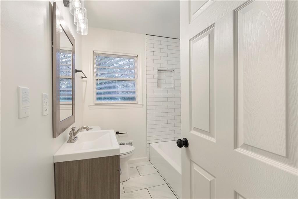 4332 Rob Roy Lane Conley, GA 30288 - Photo 12 of 21 a bathroom with a sink a toilet and shower