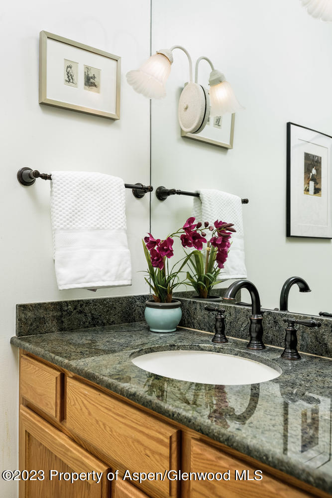 350 Riverside Drive Basalt, CO 81621 - Photo 22 of 46 a bathroom with a granite countertop sink a mirror and vanity