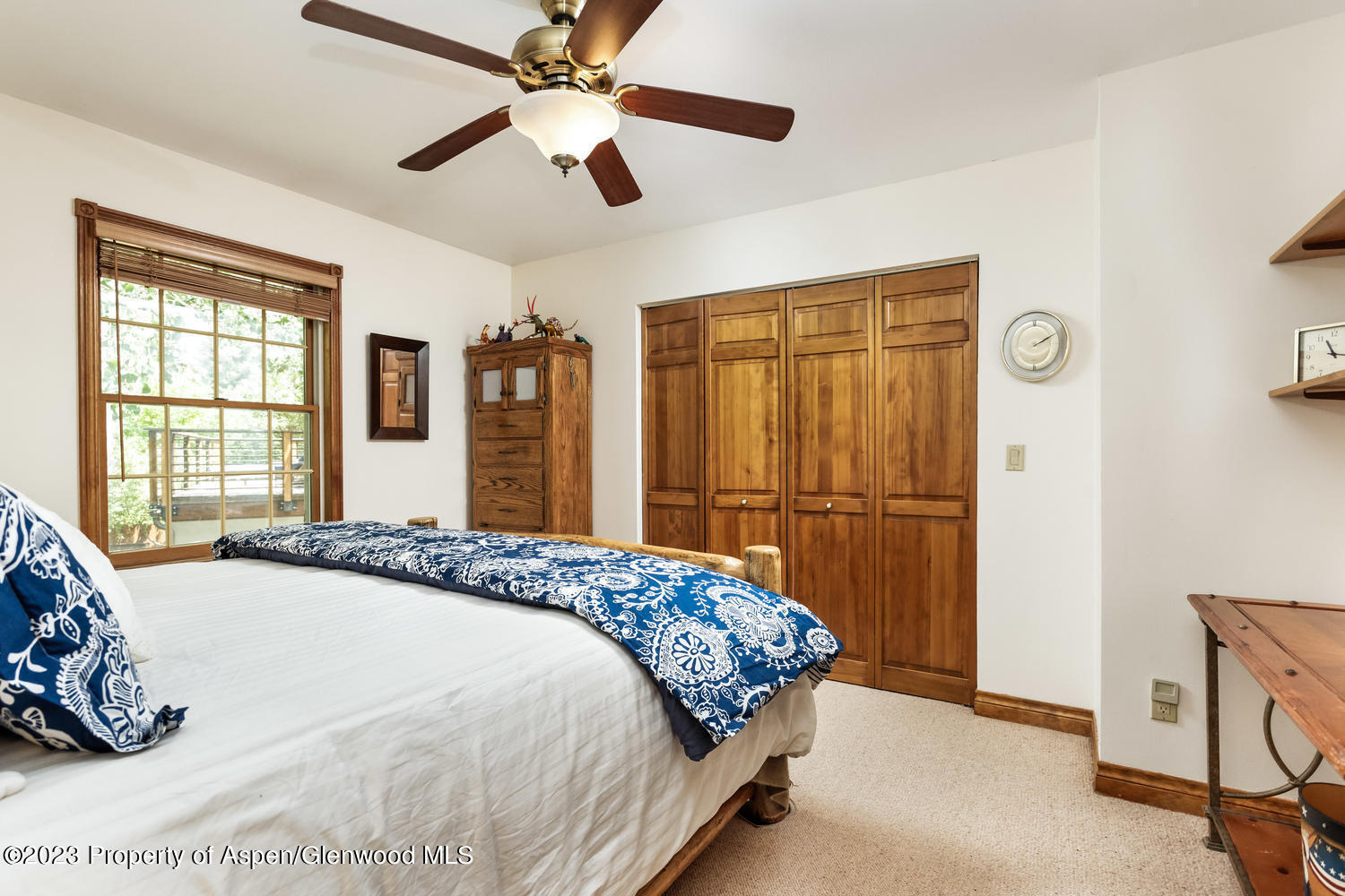350 Riverside Drive Basalt, CO 81621 - Photo 26 of 46 a bedroom with a bed and a chandelier