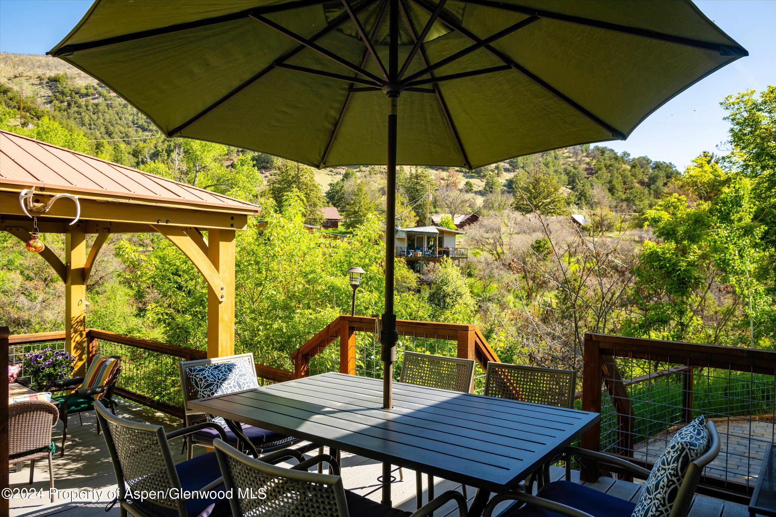 350 Riverside Drive Basalt, CO 81621 - Photo 40 of 46 an outdoor space with furniture and umbrella