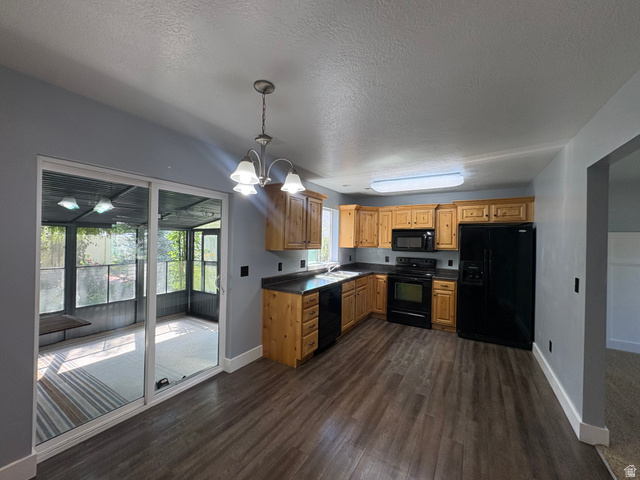 922 North 480 West Logan, UT 84321 - Photo 6 of 11 Kitchen with wood-finish flooring, natural wood cabinetry, and black appliances