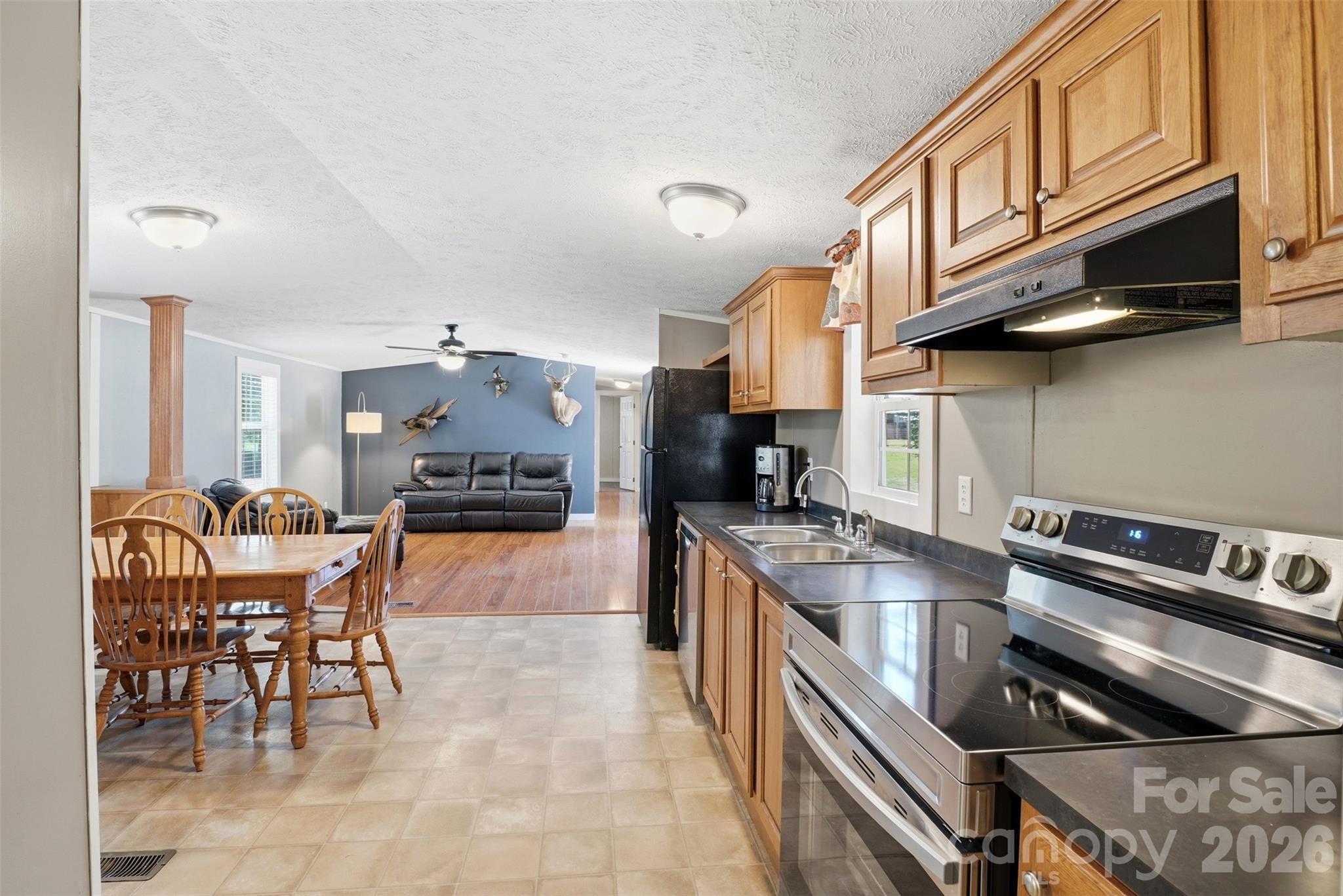 4406 Lucy Short Cut Road Marshville, NC 28103 - Photo 7 of 30 a kitchen with stainless steel appliances granite countertop a sink and cabinets