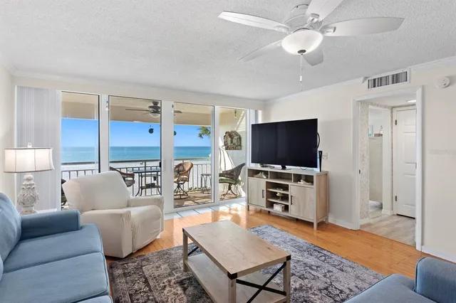 a living room with furniture a rug and a chandelier