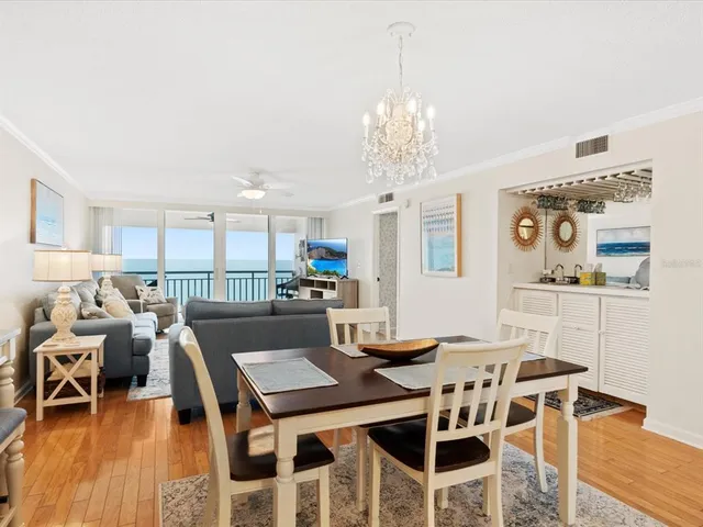 a very nice looking living room with kitchen and furniture