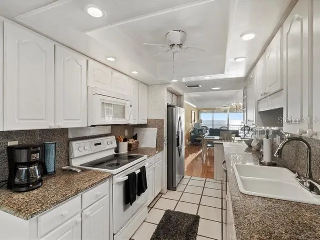 a kitchen with a sink stainless steel appliances and cabinets