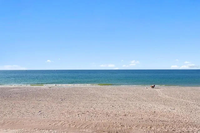 a view of a room with an empty space and wooden floor