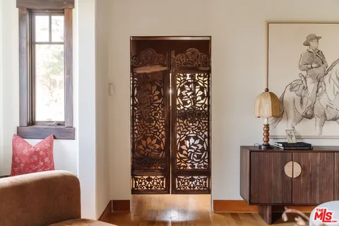 a view of a dining room with furniture large windows and wooden floor