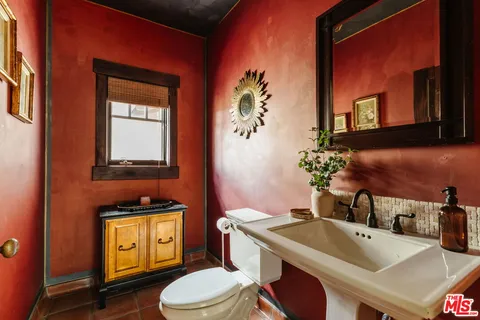 a bedroom with furniture and a large window