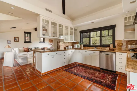 a spacious bathroom with a bathtub double sink and mirror