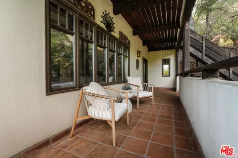 a view of a balcony with an outdoor seating