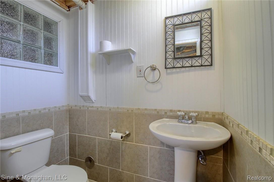 52075 Lillian Road New Baltimore, MI 48047 - Photo 29 of 34 31-Finished Lower Level Half Bath.jpg