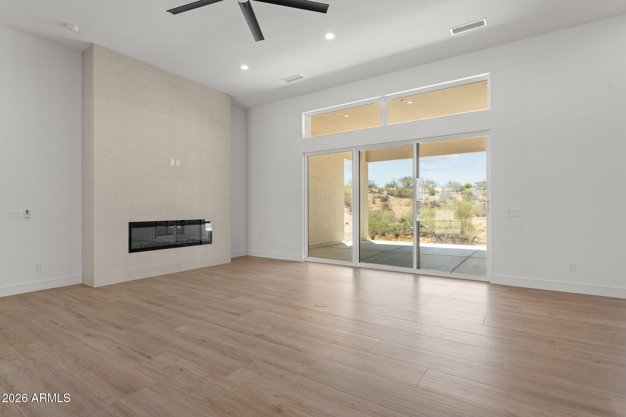 2855 Percheron Road Wickenburg, AZ 85390 - Photo 12 of 58 an empty room with wooden floor and windows
