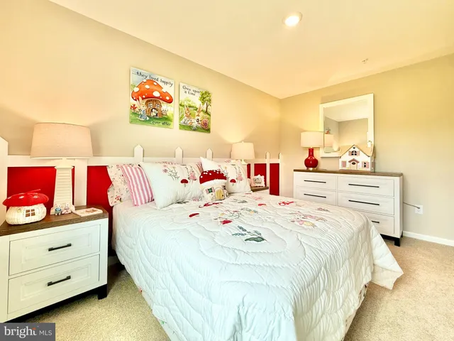 a bedroom with a bed and a dresser